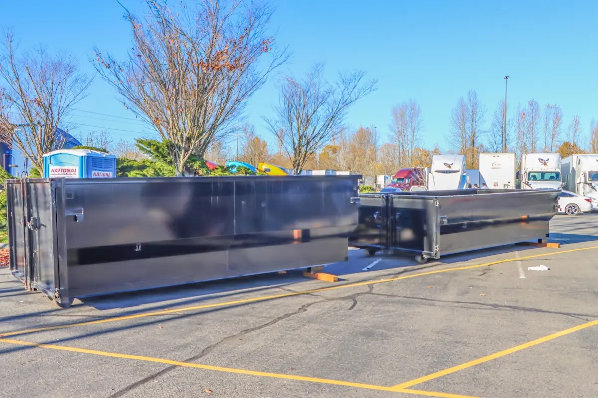 Professional dumpster rental service with roll-off container on residential driveway in Liberty Lake